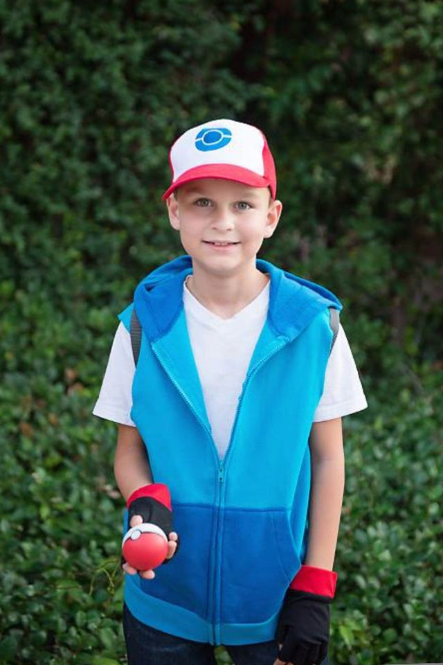 Boy dressed as Ash from Pokemon with a red and white cap, a blue vest and a Poke Ball