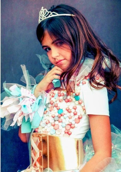 Girl in a Candyland princess costume with a tiara and a candy-covered top