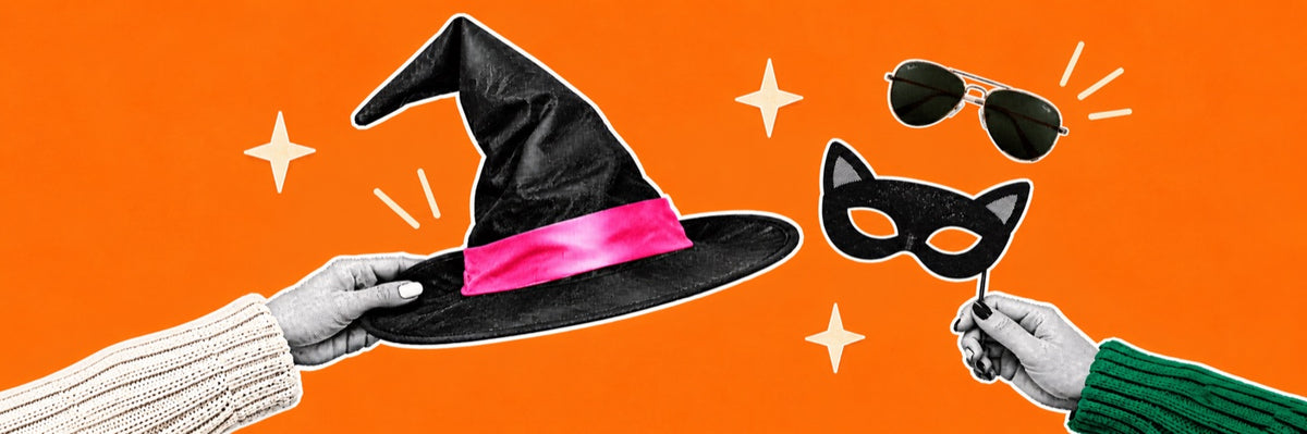 Two hands on an orange background, one holding a black witch hat with a pink band and the other a black cat mask, with aviator sunglasses floating nearby