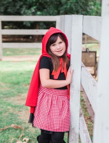 Little Red Riding Hood costume with a red hooded cape and red gingham skirt
