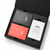 That Gift Game open box showing its three card decks, a gift exchange game for 4 to 14 players
