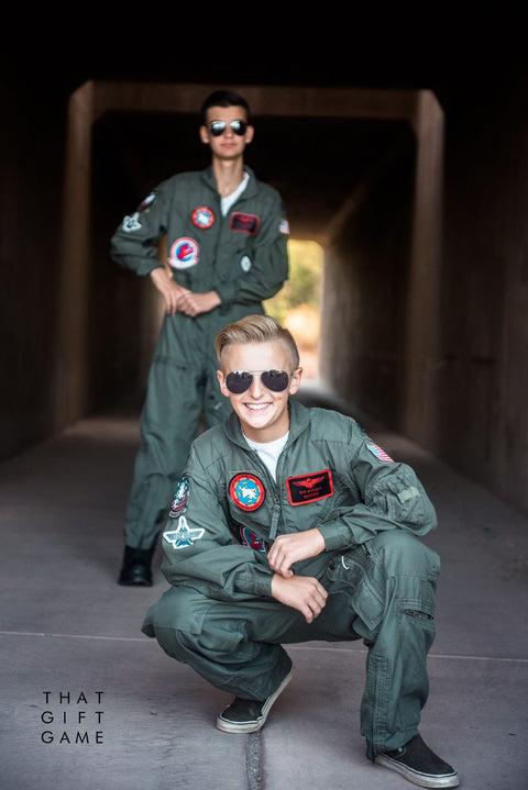 Maverick and Goose costumes, one boy crouching in front in aviators